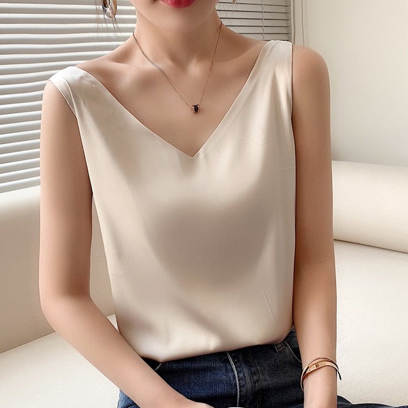 Champagne Trigala V-neck tank top worn with dark trousers.