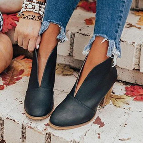 Black ankle boots with rounded toes and a deep notch at the front.