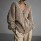 Beige V-neck cardigan with a button front and loose sleeves.
