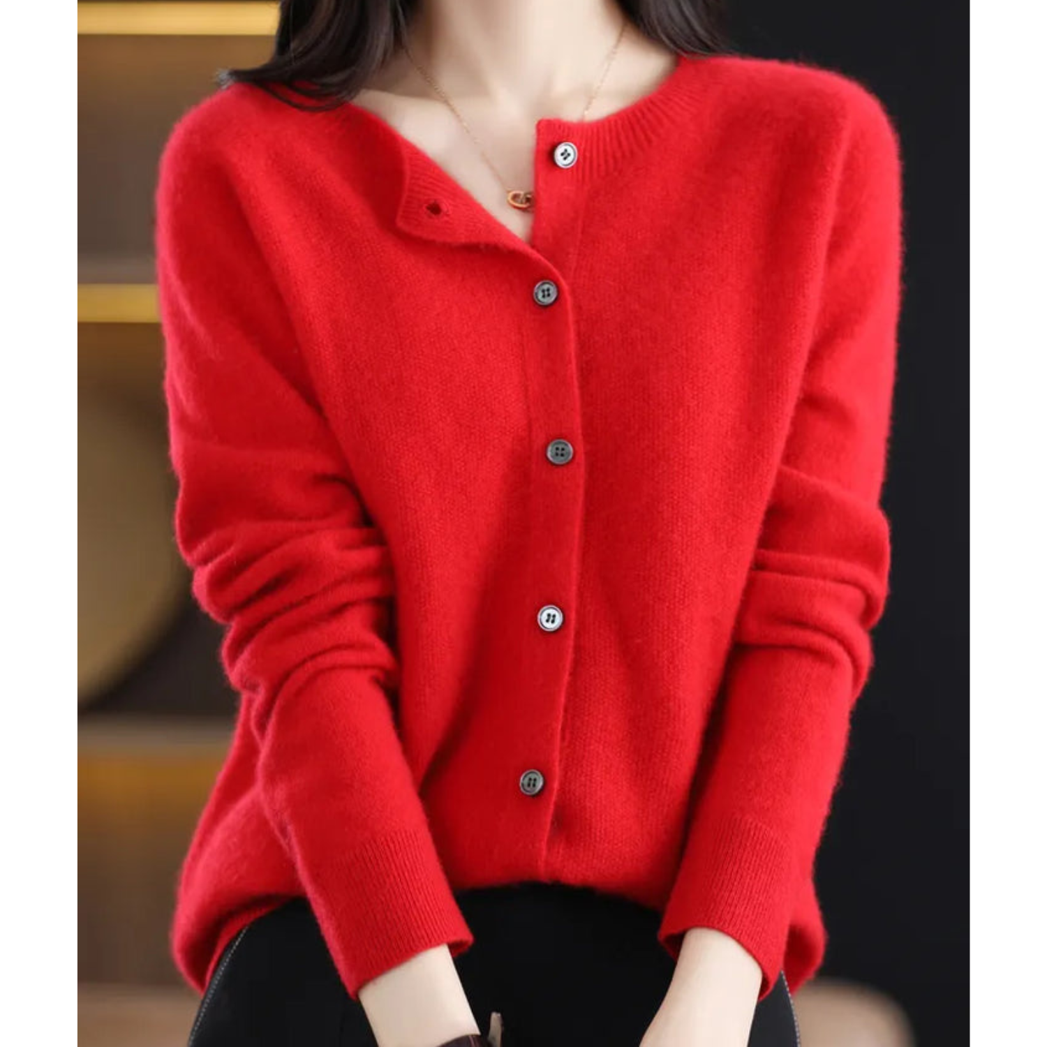 Red cardigan with ribbed cuffs and buttons along the front.