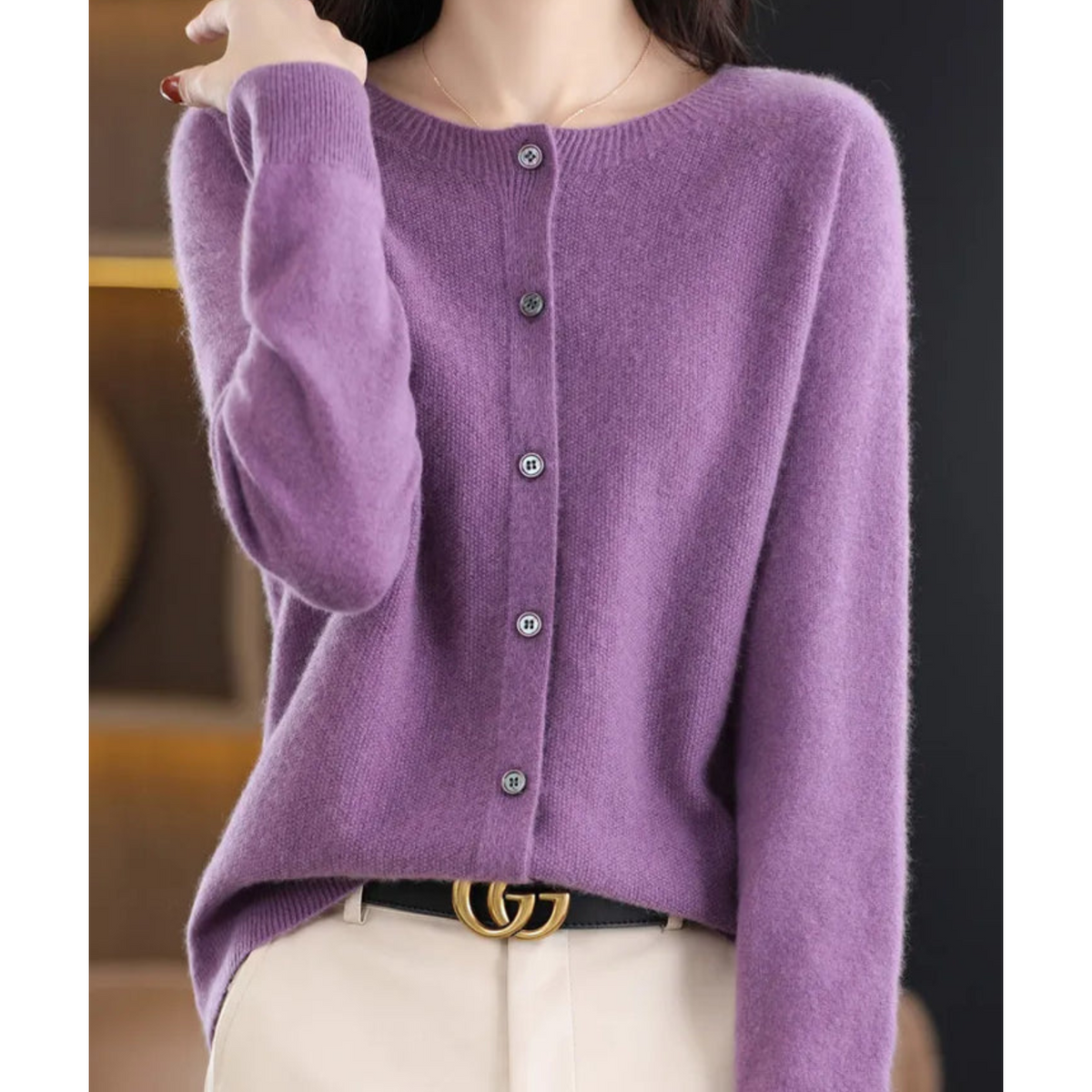 Purple cardigan with a round neck and long sleeves.
