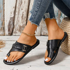 Black toe-loop slide sandals with layered straps, side buckles and stitched sole edges.