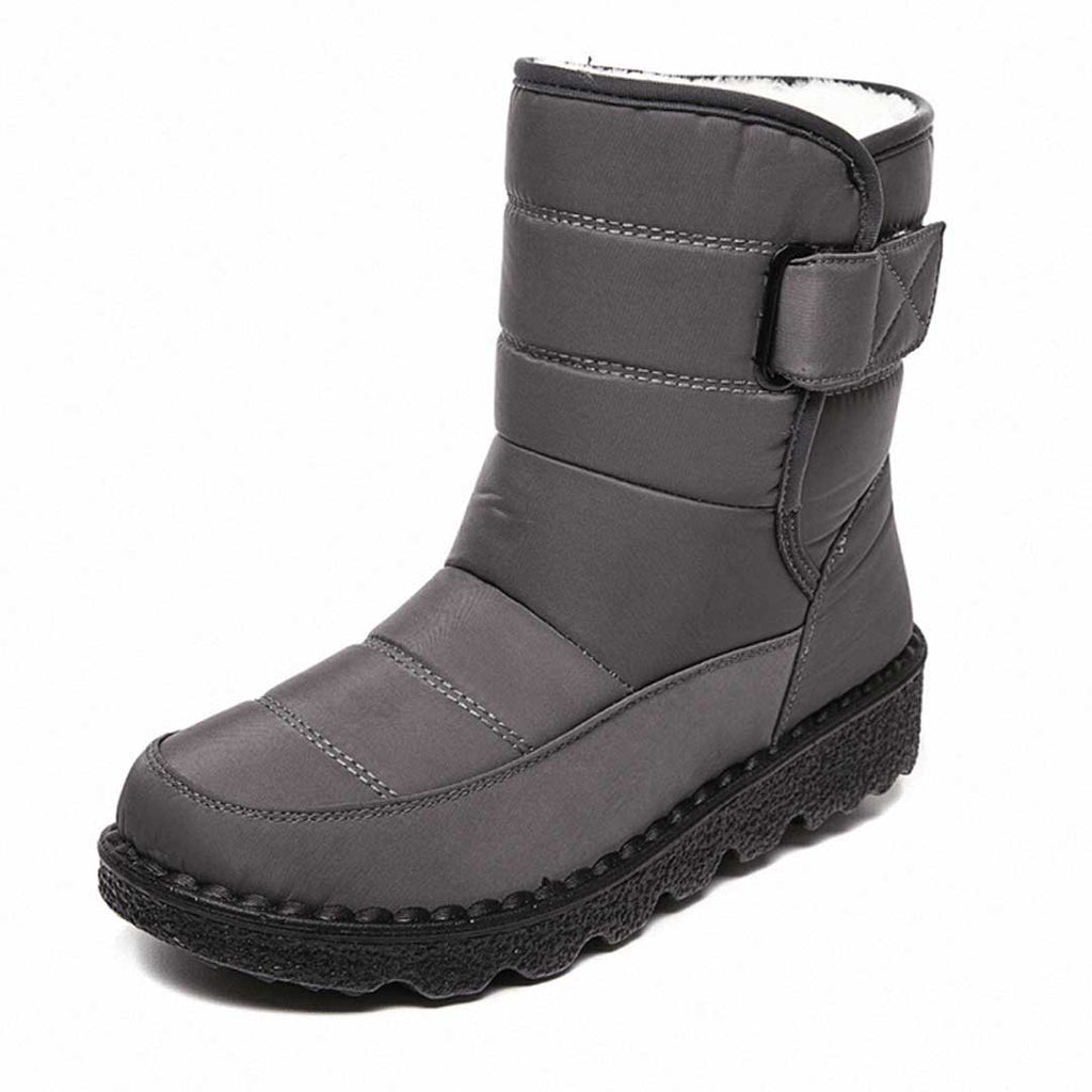 Grey lined winter boot with an upper strap and stitched toe panel.