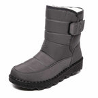 Grey lined winter boot with an upper strap and stitched toe panel.