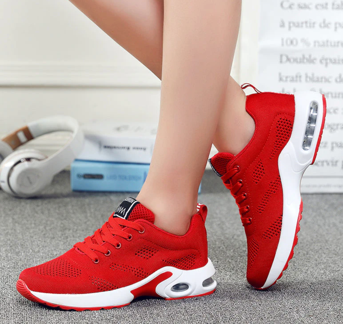 Red trainers with lace-up fronts and oval heel sections.