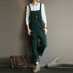 Green corduroy dungarees with front patch pockets and loose legs.