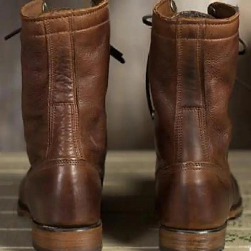 Back view of dark brown boots with stitched vertical panels.