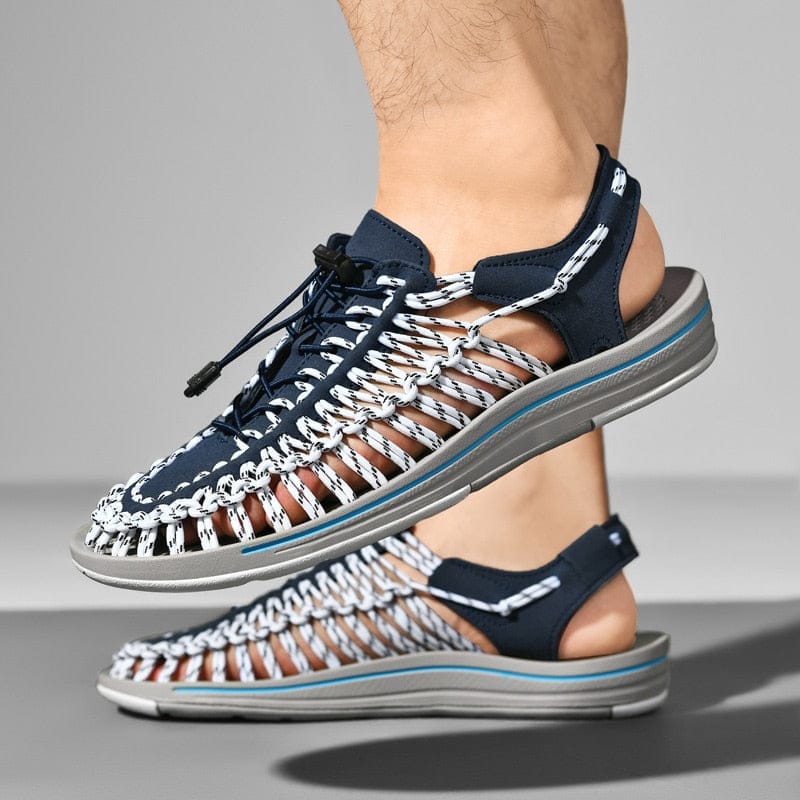 Blue and white cord sandals with open sides and slingback heels, worn in side view.