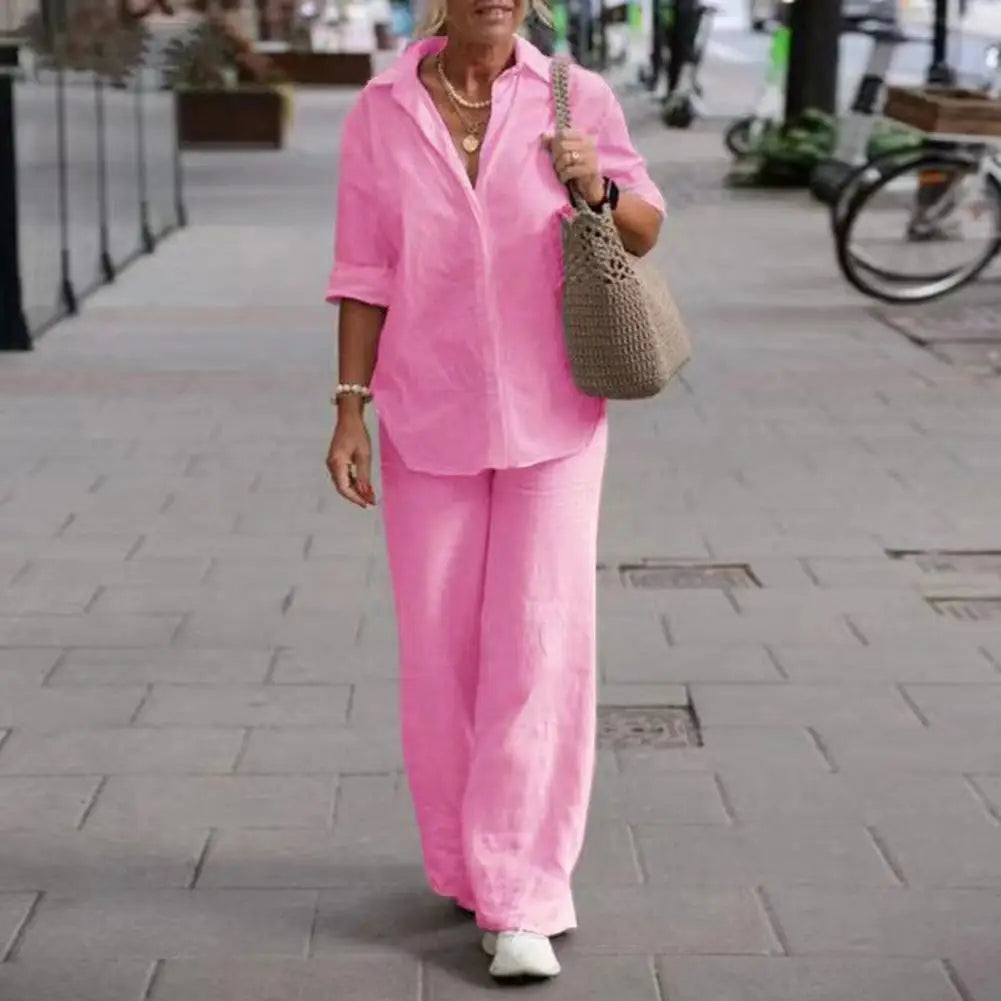 Pink collared shirt with turned-up sleeves and matching full-length trousers.