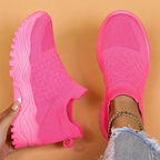 Bright pink slip-on trainers with small heel loops.