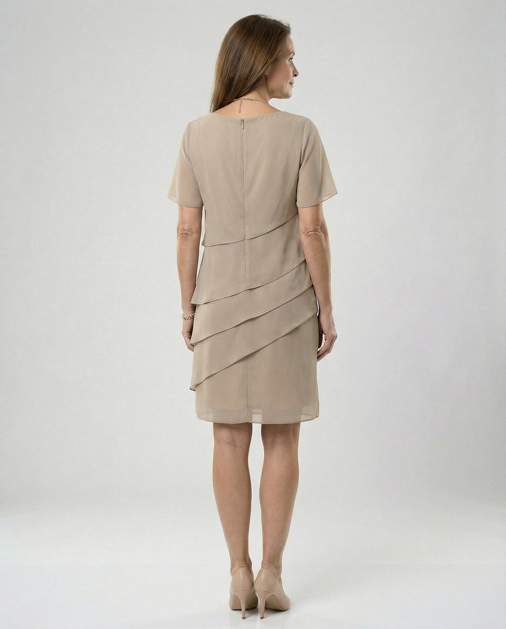 Back view of a khaki dress showing its upper zip and diagonal panels.