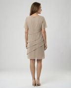 Back view of a khaki dress showing its upper zip and diagonal panels.