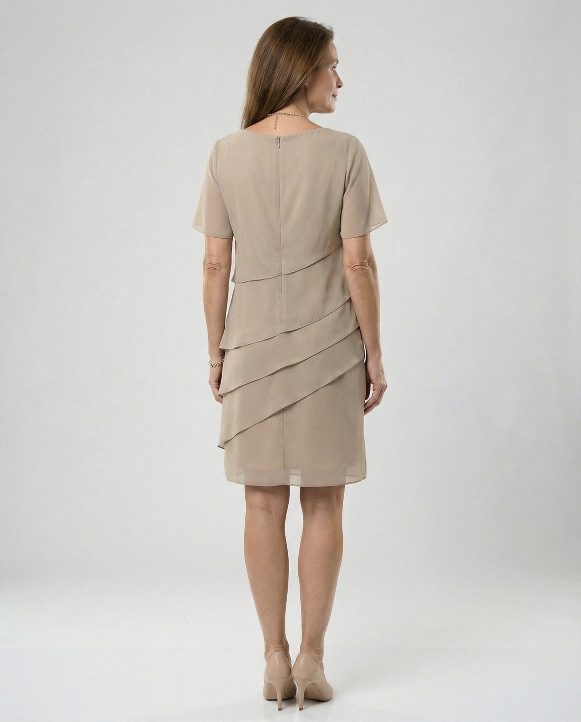 Back view of a khaki dress showing its upper zip and diagonal panels.