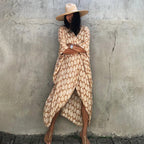 Turmeric-toned leaf-print cover-up worn open at the front.