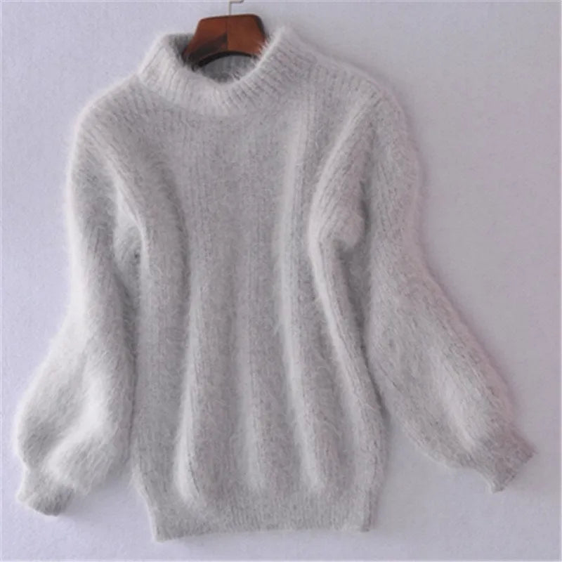 Grey fuzzy knit jumper with a high neckline and narrow sleeve cuffs.