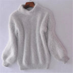 Grey fuzzy knit jumper with a high neckline and narrow sleeve cuffs.