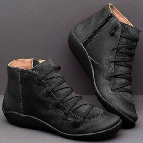 Black ankle boots with textured uppers and side zip fastenings.