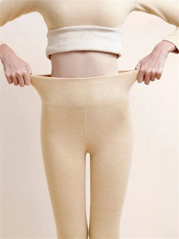 Beige high-waist leggings with the wide waistband held out at both sides.