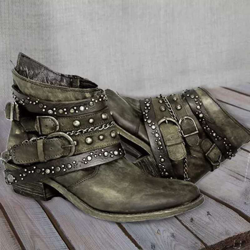 Green vintage ankle boots with studded straps and a worn-in surface.