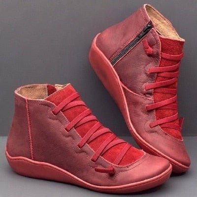 Red ankle boots with front laces, side zips and matching red soles.