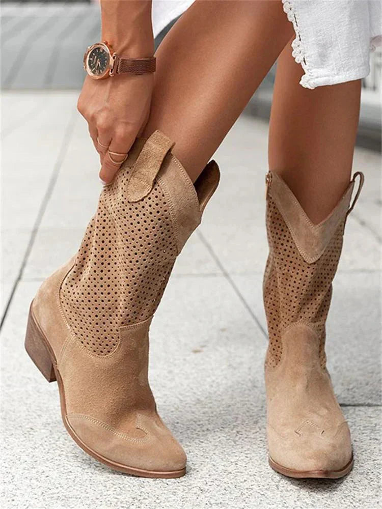 Brown western boots with perforated panels shown on steps.
