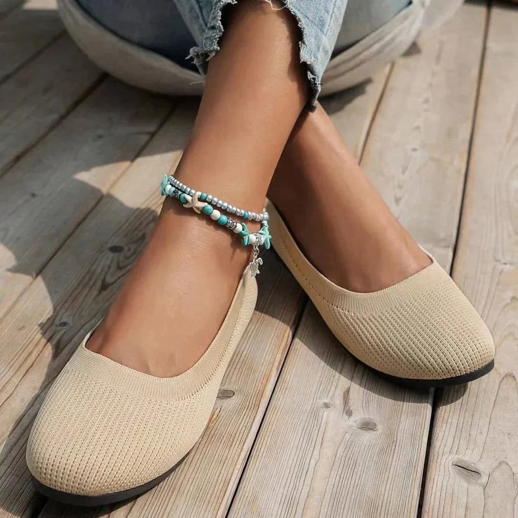 Beige flats worn with cropped jeans.