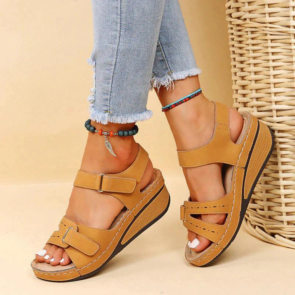 Mustard-coloured wedge sandals with cutout fronts.