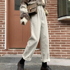 White ribbed trousers with rolled hems, shown outdoors.