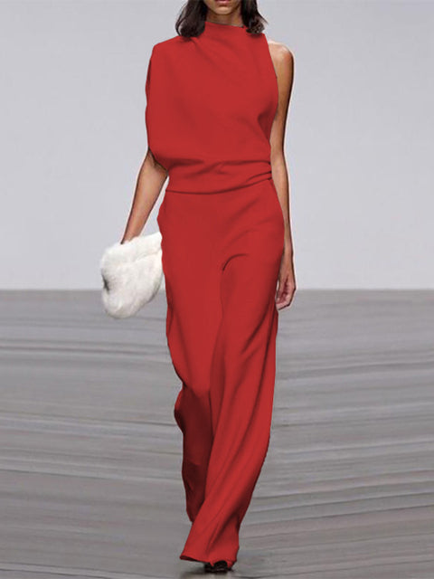 Red jumpsuit with a draped upper section and defined waist.