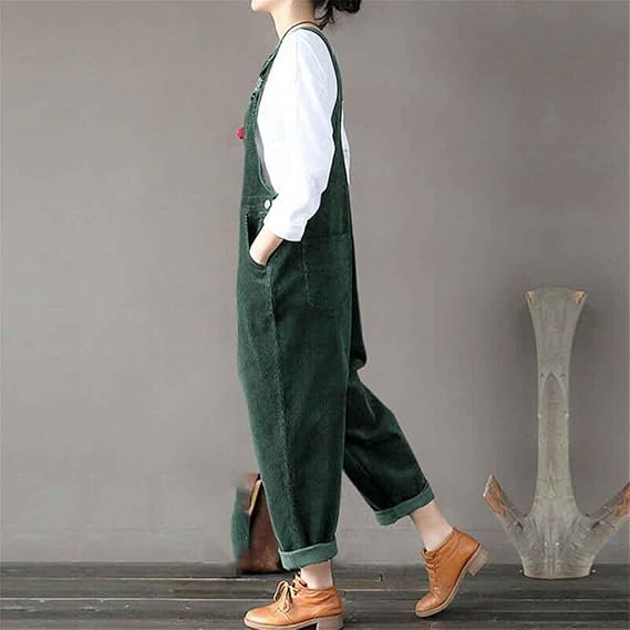 Side view of green corduroy dungarees showing a front pocket and loose fit.