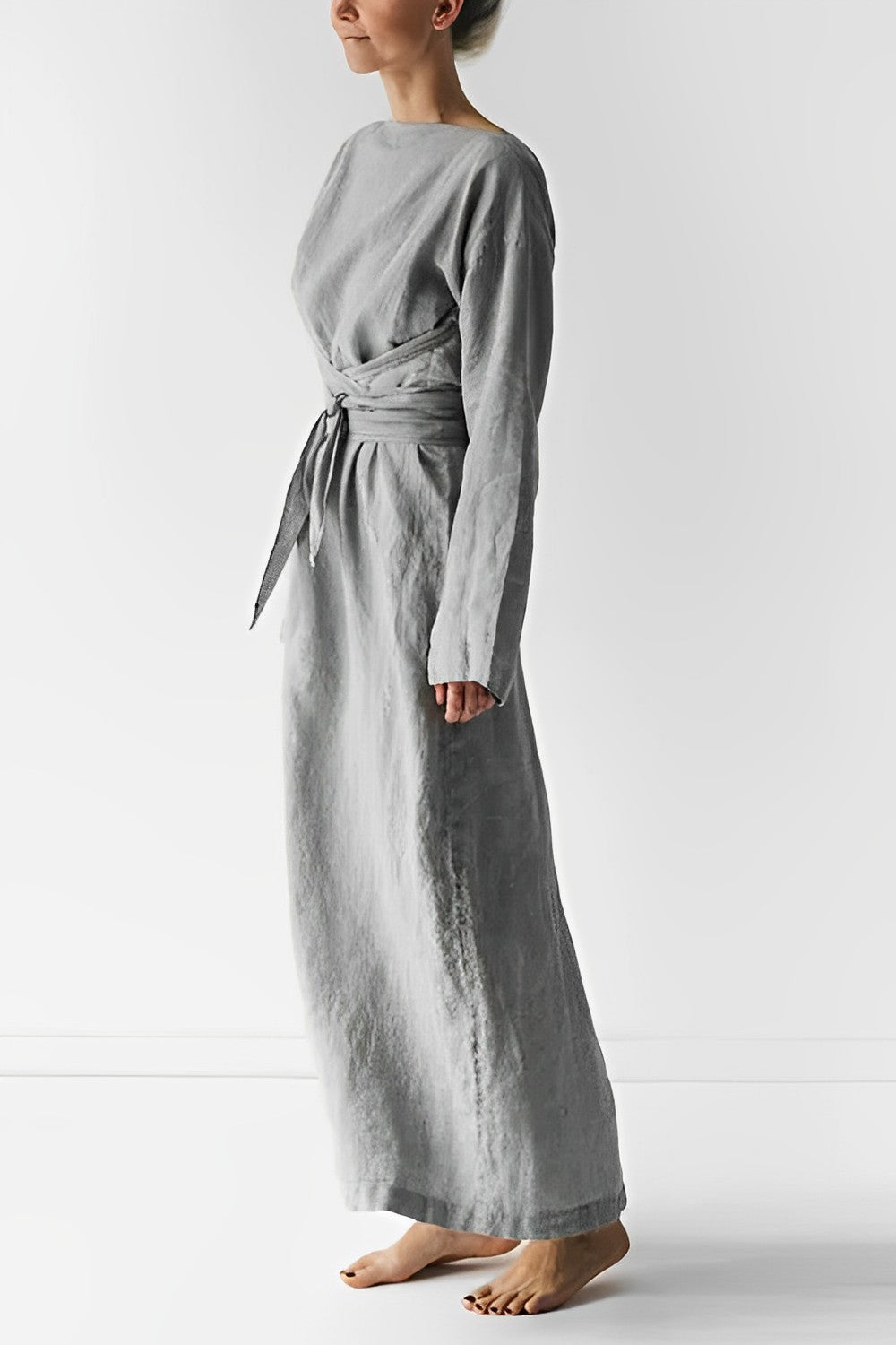 Grey long-sleeve dress with a tied waist, shown from the side.