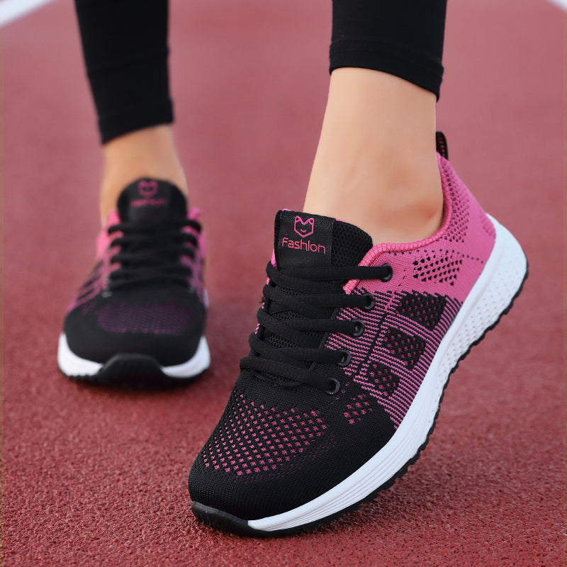 Black-and-pink trainers with dark laces and white soles.