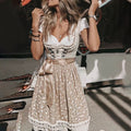Beige dirndl with a lace-up bodice, white short-sleeved blouse and floral apron with a lace-edged hem.