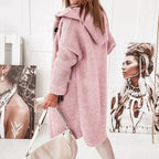 Pink hooded cardigan with ribbed cuffs and a long knit body.