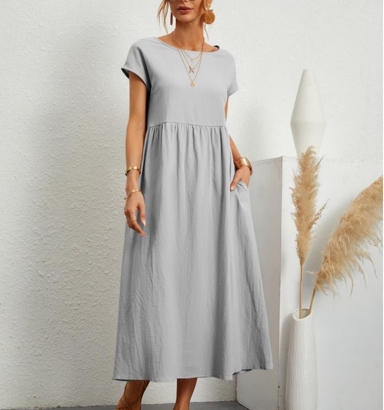 Silver grey Ginovu dress with a round neckline and long skirt.