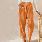 Orange corduroy trousers with a front waist button.