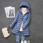 Blue-grey puffer coat with side pockets and a hood.