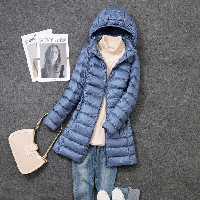 Blue-grey puffer coat with side pockets and a hood.