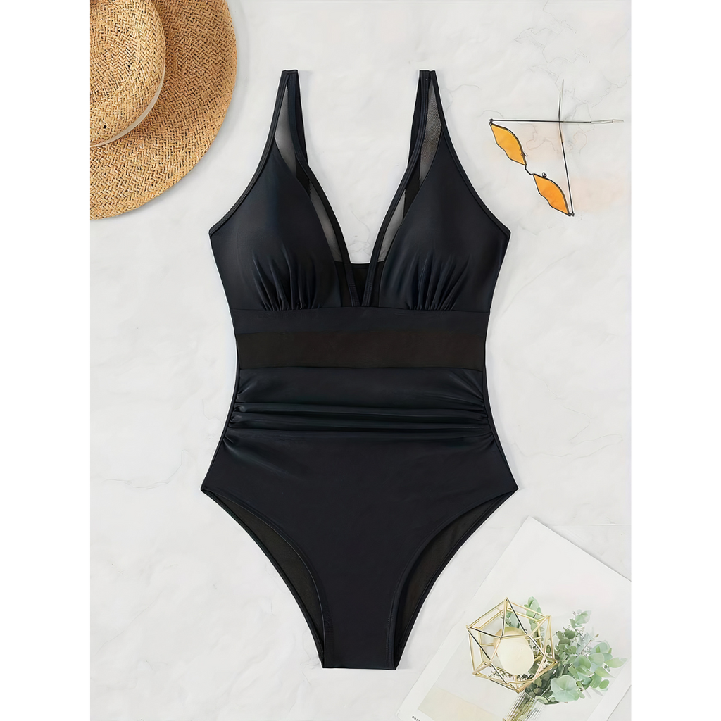 Black swimsuit laid flat, with a gathered front and mesh waist panel.