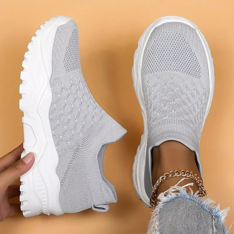 Light grey trainers viewed from above and the side.
