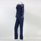 Dark blue lace jumpsuit with a matching waist tie and long sleeves.