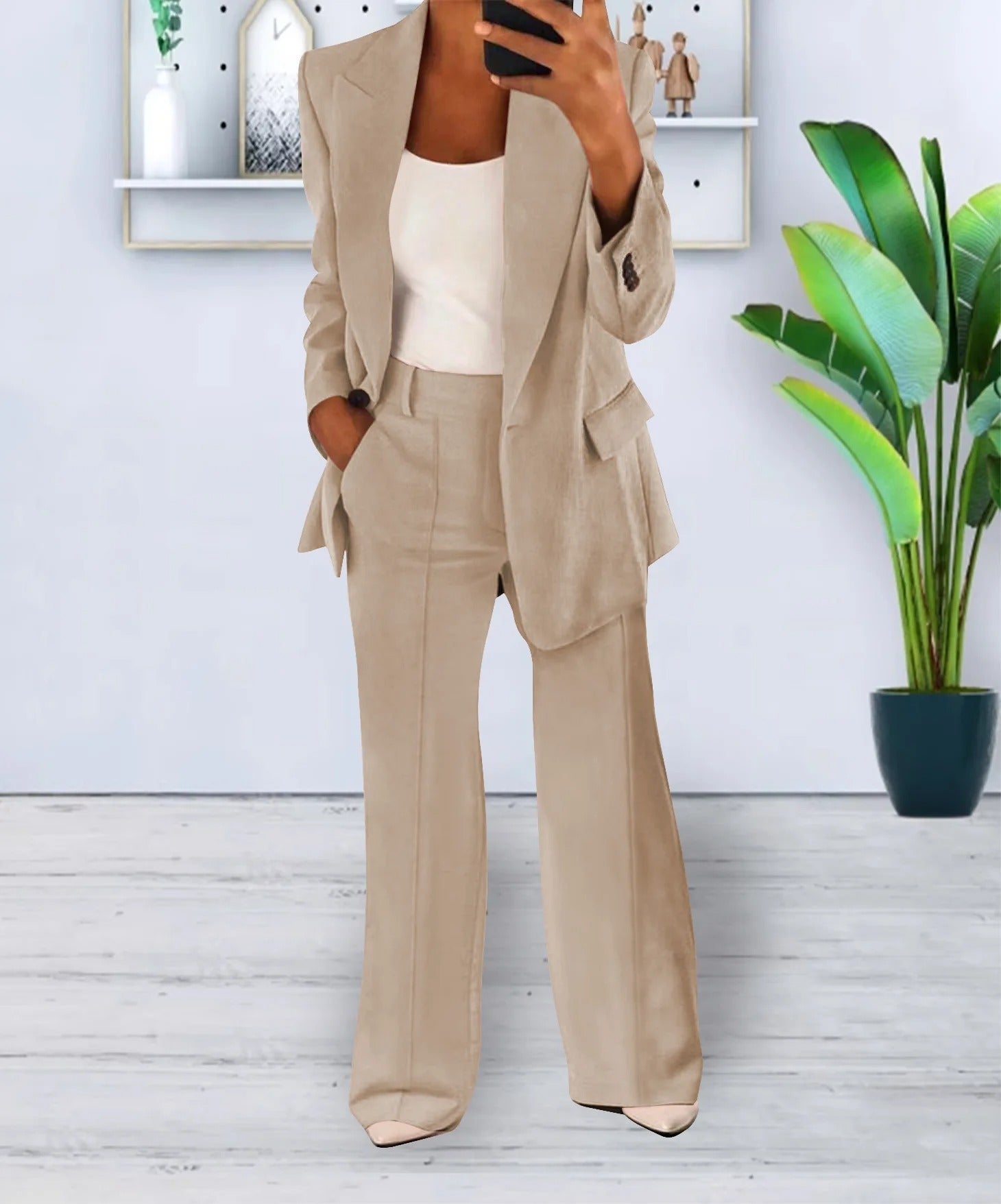 Beige two-piece trouser suit shown from the front.