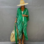 Green printed cover-up over a white swimsuit.
