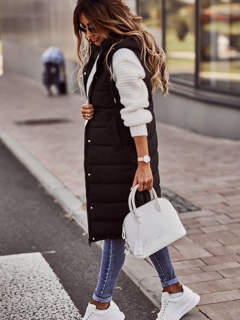 Side view of the black gilet worn over a cream jumper.