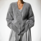 Grey fluffy cardigan with a V neckline, worn over a light top.