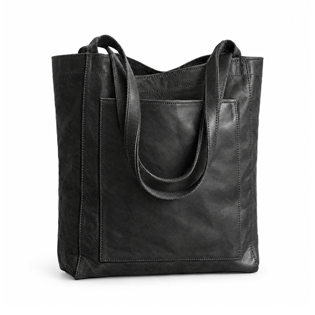 Black shoulder tote bag with long handles and a front patch pocket, angled view