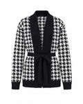 Black/White houndstooth knit cardigan photographed straight on, open front with a black ribbed shawl band and a tie belt knotted at the waist