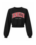 Cropped Brooklyn graphic sweatshirt in Black, front view: BROOKLYN in red varsity letters over NEW YORK, raglan sleeves and ribbed waist-length hem
