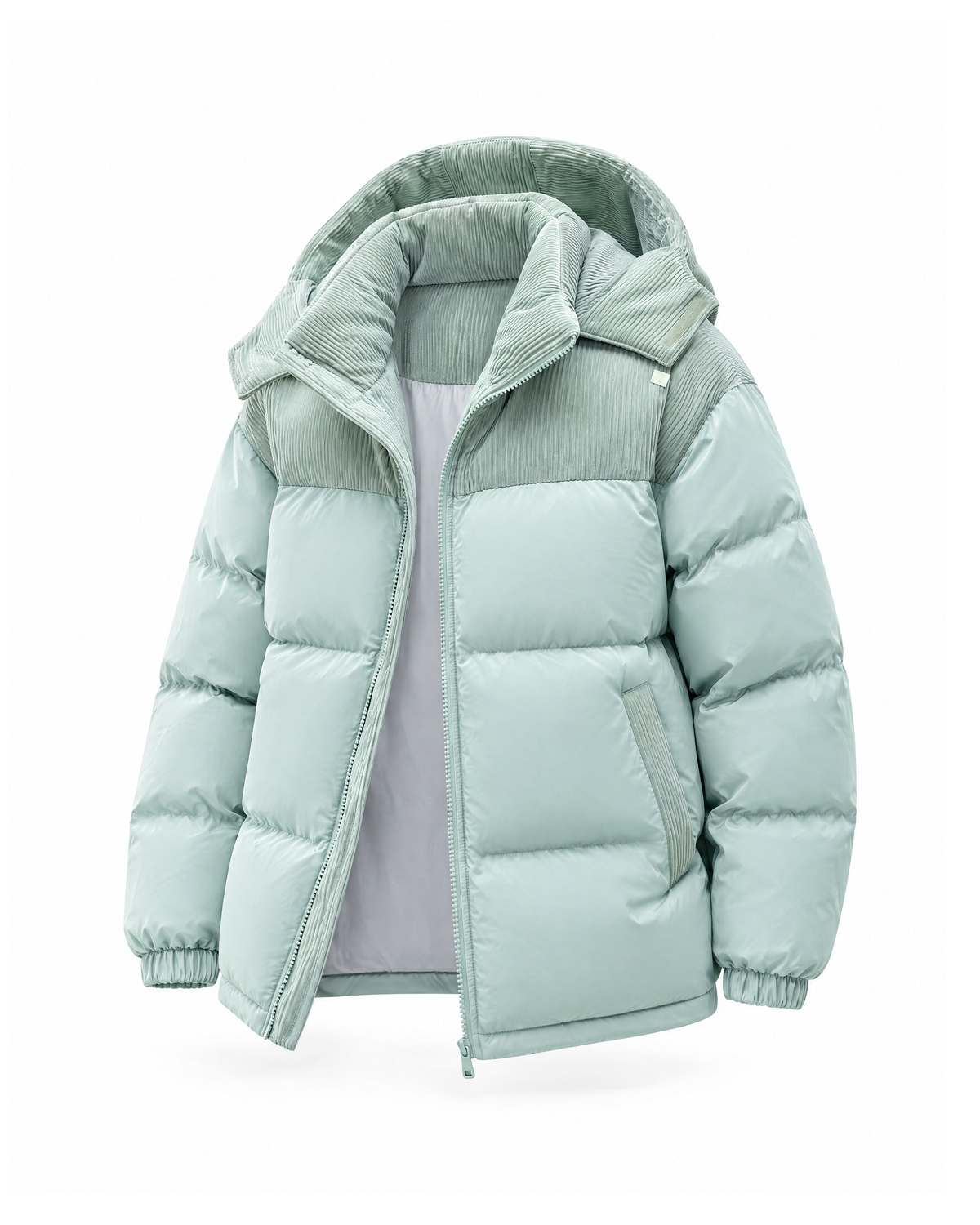 Three-quarter front view of the Mint puffer jacket showing the corduroy yoke, slanted welt pocket and elasticated cuff